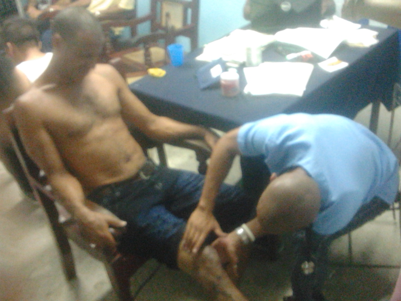 A doctor attends to Roberto Formigo, a UNPACU activist, after being assaulted by police.