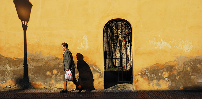 Woman walking down a street in Prague, Czech Republic