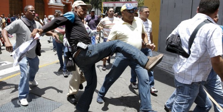 Pro-government activists attacked Leopoldo Lopez's supporters as they waited for the sentence to be announced.