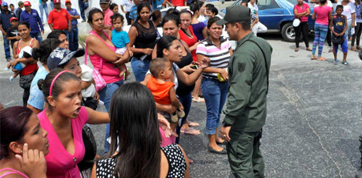 Venezuelan military personnel often give parents with young children priority in long lines for basic goods. 