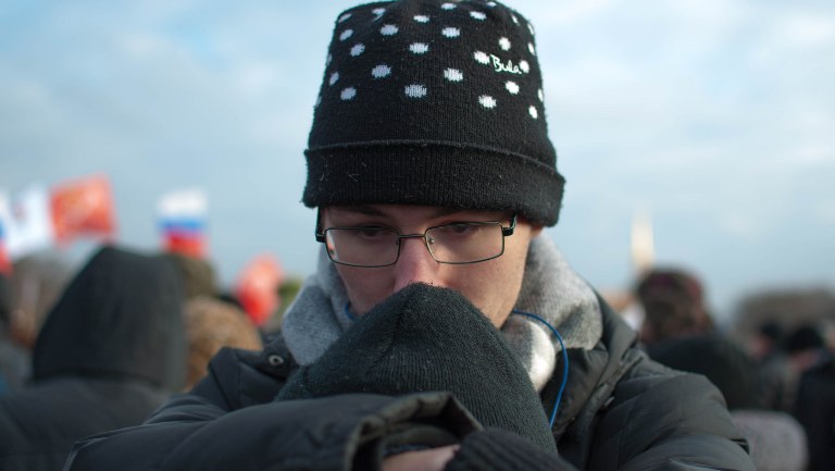 A young Russian prays during a demonstration held in honor of Boris Nemtsov in Moscow.